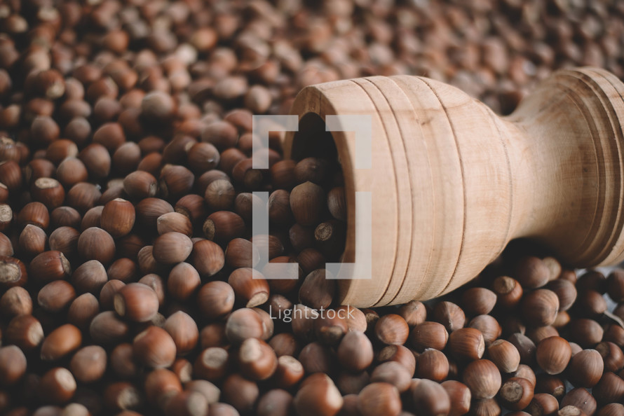 Hazelnuts in a wooden bowl on rustic background