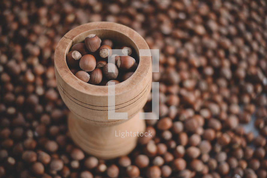 Hazelnuts in a wooden bowl on rustic background