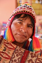 Peruvian weaver showing hand woven garment 
