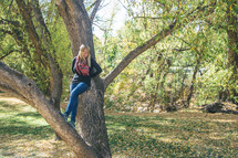 a woman standing in a tree 