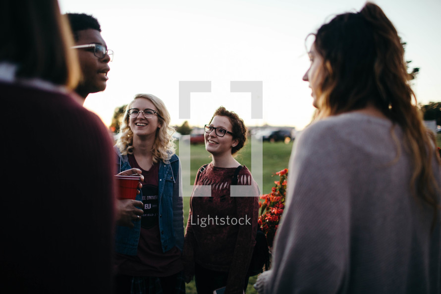 young adults having conversations outdoors 