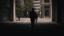 silhouette walking on a downtown street 