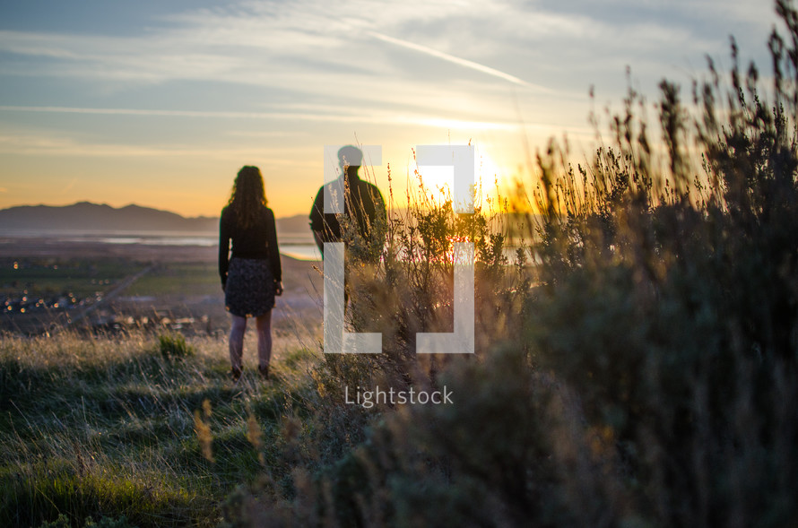 couple standing outdoors at sunset 