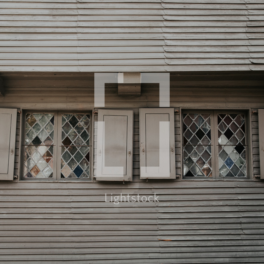 shutters and stained glass windows on a house 