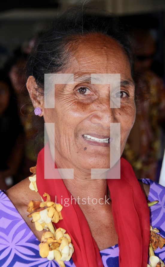 elderly woman wearing a lei