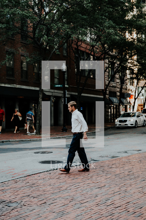 a man walking on a downtown sidewalk 