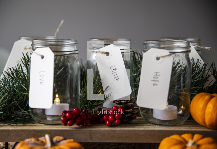 Tealights in jars for advent with pumpkins and Christmas decor