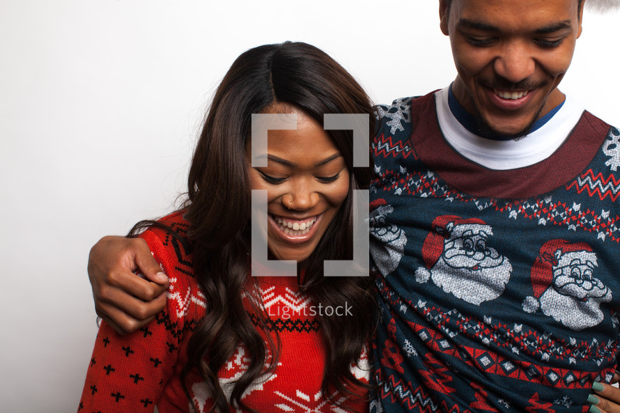 couple in ugly Christmas sweaters 