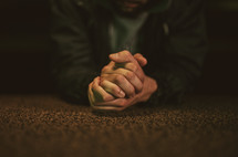 a man kneeling to pray at the altar