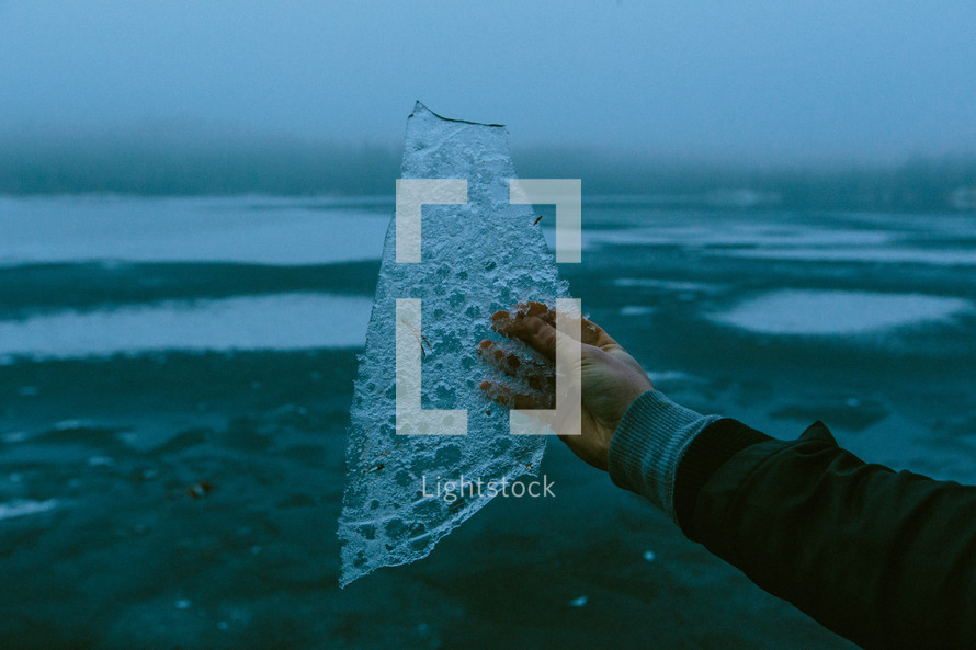 man holding ice from a lake 