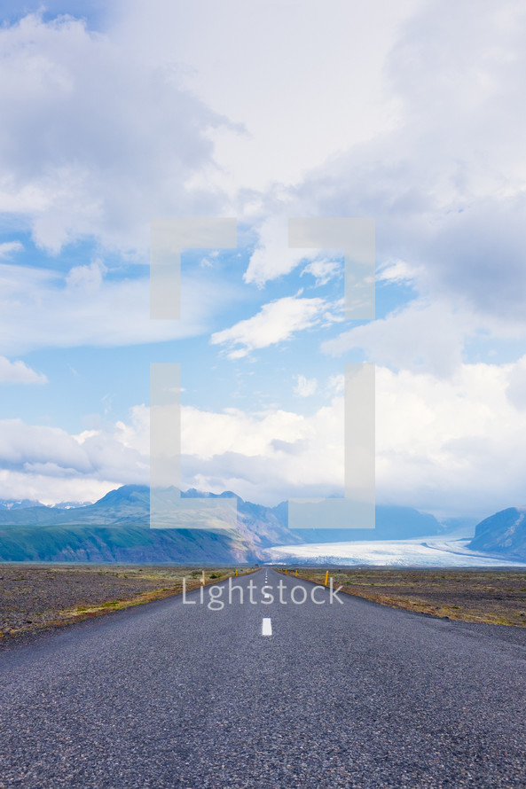 mountain road under a cloudy sky
