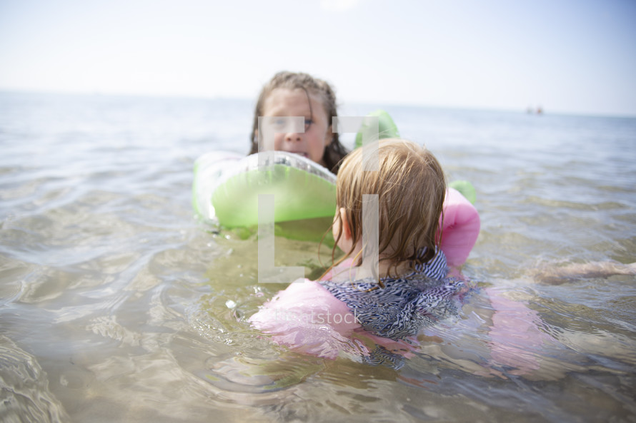 kids swimming in the ocean 
