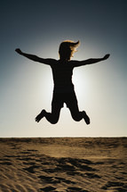 silhouette of a woman leaping in the air 