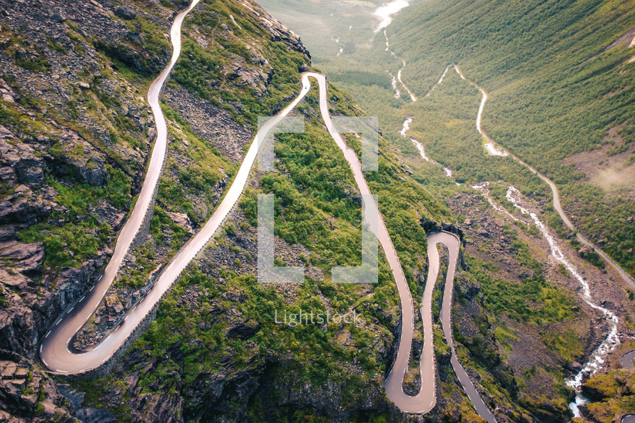 a winding mountain road and river 