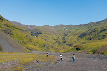 people hiking in a mountain valley 