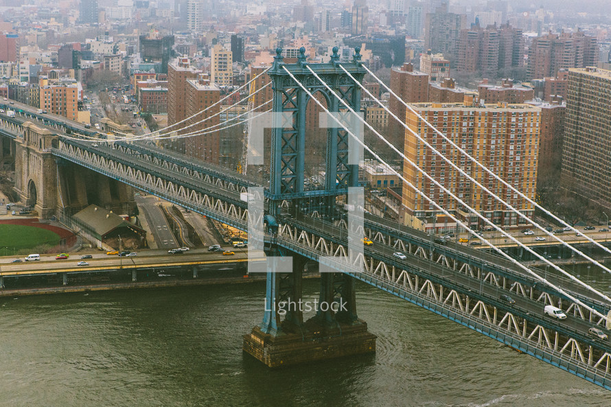 aerial view over a city bridge over water 