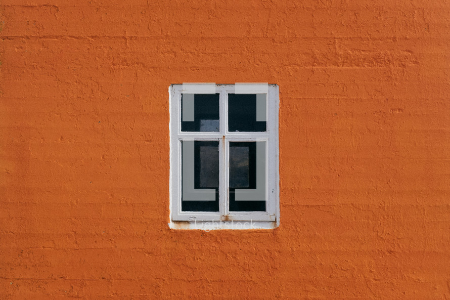 window on an orange exterior wall 