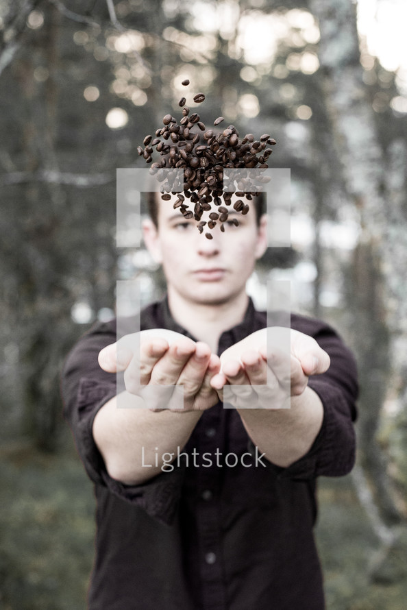 man catching coffee beans 