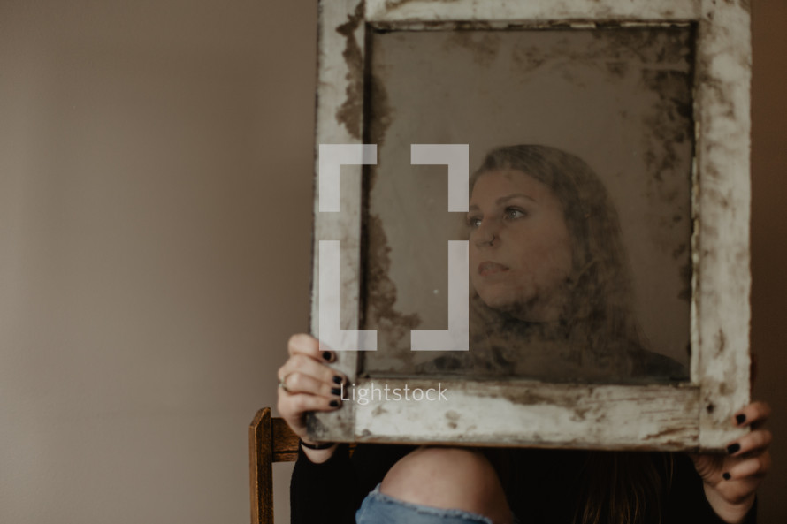 portrait of a woman through mirrored glass