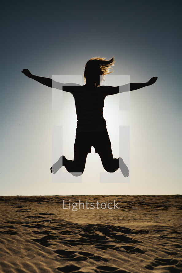 silhouette of a woman leaping in the air 