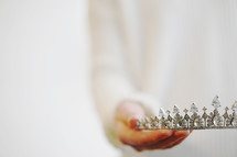 a woman holding a tiara 