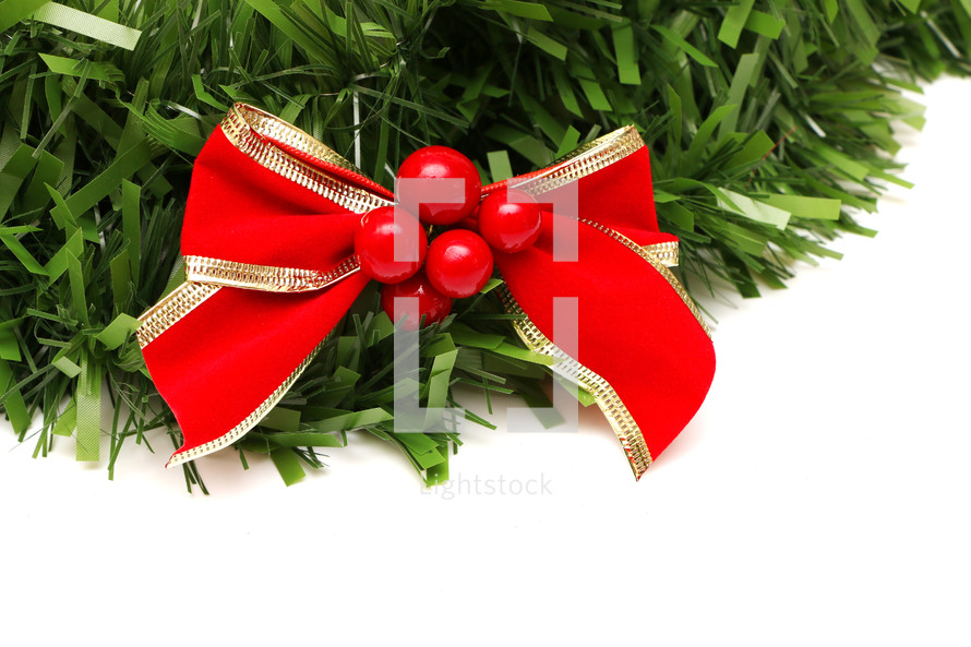 red bow and berries on a wreath 