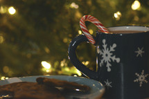 candy cane in a mug of hot cocoa 