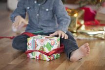 A child opening a Christmas present. 