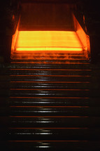 Hot steel plate on conveyor in steel plant
