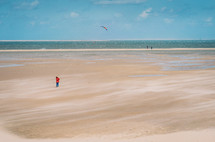 Kid with a kite on a sandy beach