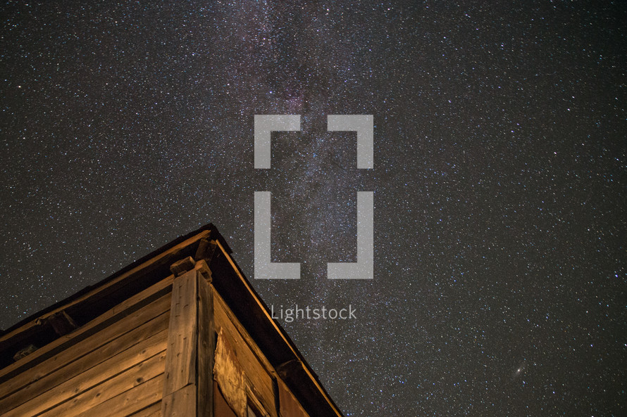 Milky Way galaxy and a wooden hut
