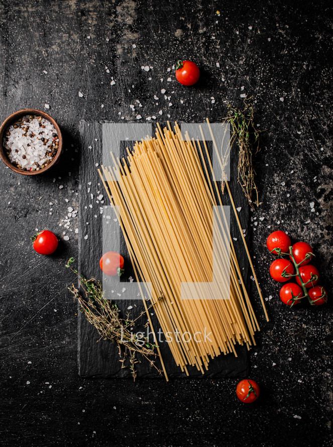 A pile of spaghetti dry on the table. Against a dark background. High quality photo