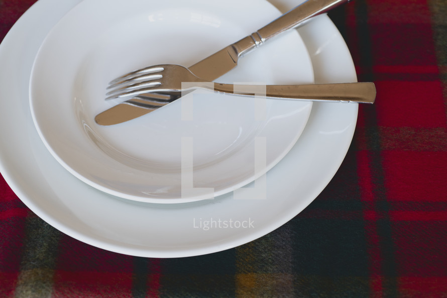 white plates with fork and knife 