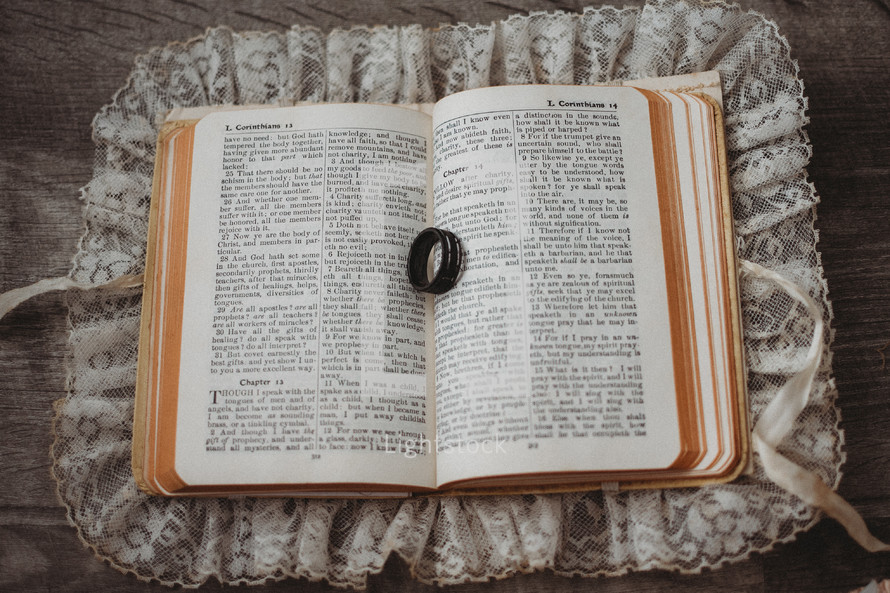 wedding band on the pages of a Bible 
