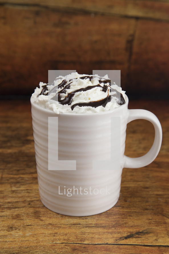 mug with whipped cream and chocolate syrup 