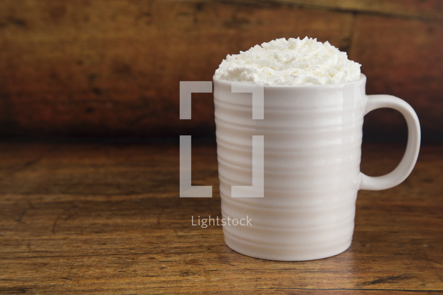 hot drink in a mug with whipped cream 