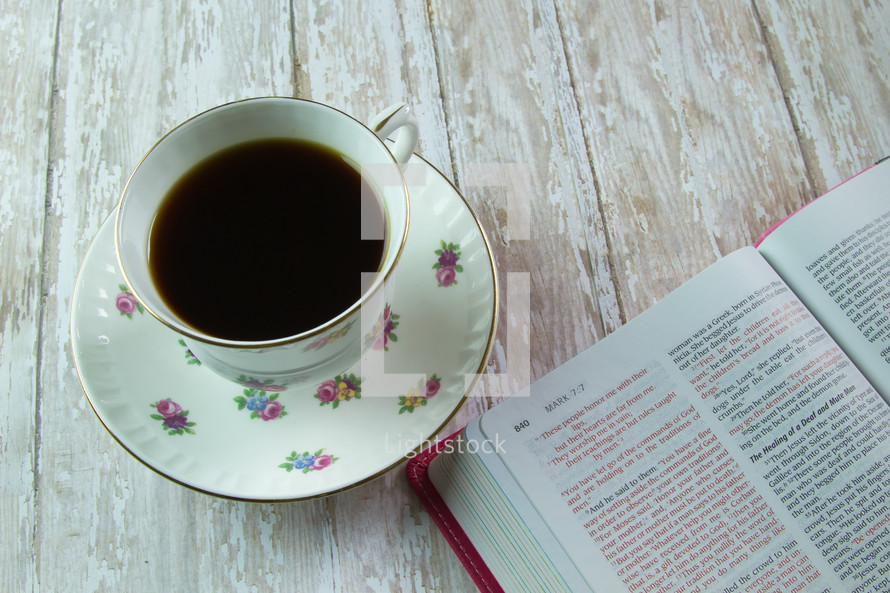 pink Bible and floral print coffee cup 