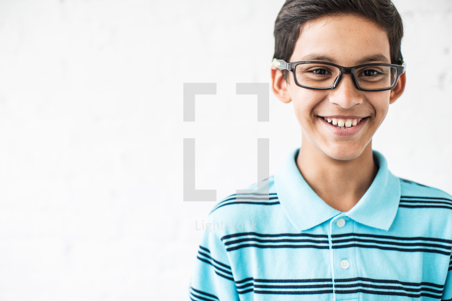 smiling boy child wearing reading glasses 