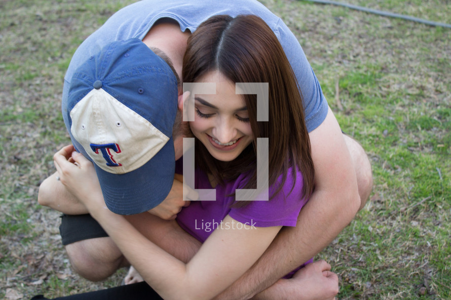 teen boyfriend and girlfriends hugging 