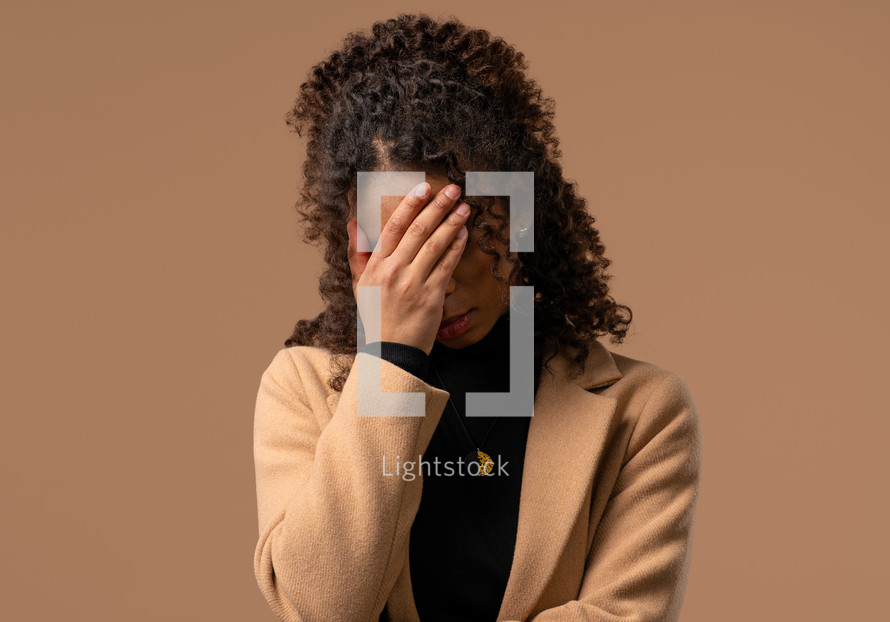 Worried confused woman, no, she forgot. Sad girl feeling sorrow, regret, drama, failure, problems on beige background. Facepalm. High quality