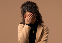 Worried confused woman, no, she forgot. Sad girl feeling sorrow, regret, drama, failure, problems on beige background. Facepalm. High quality