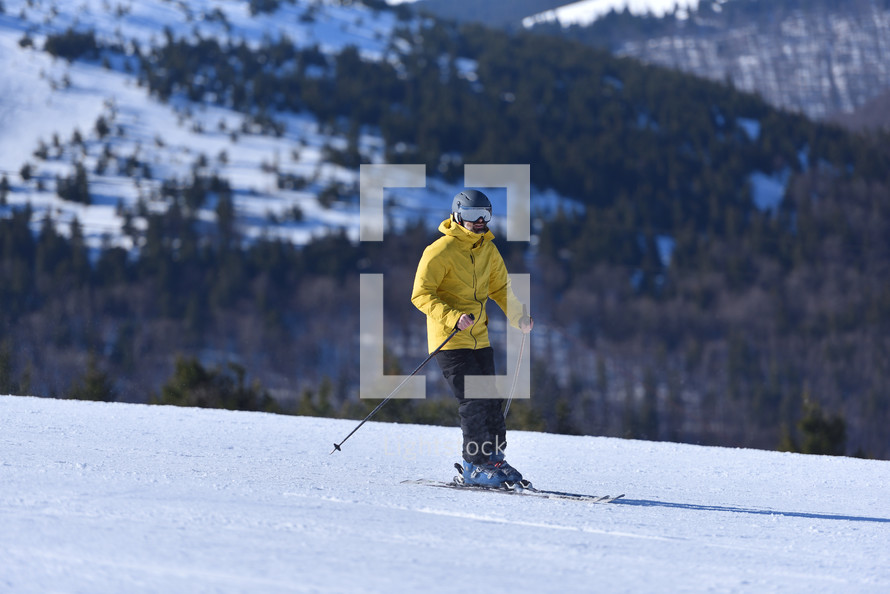 A Perfect Day for Skiing - Adventurous Man Tackles the Slopes on a Bluebird Day with the Stunning Mountain Landscape as His Companion