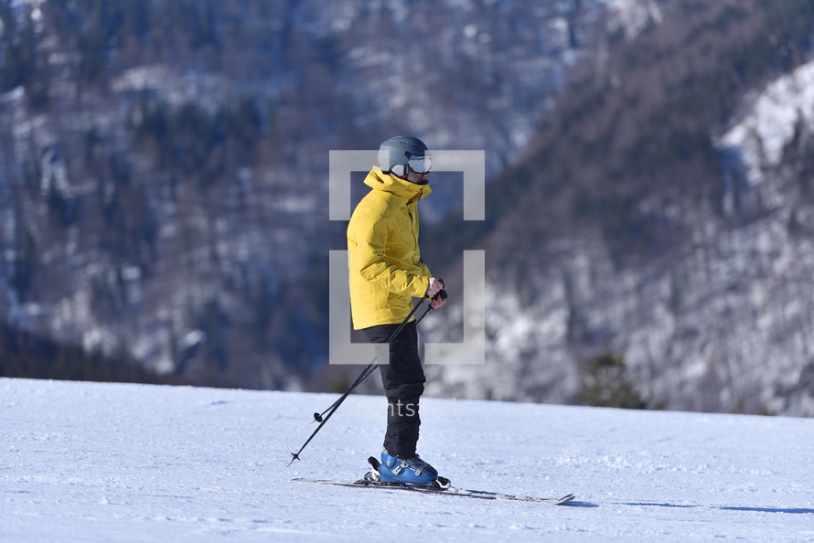 A Perfect Day for Skiing - Adventurous Man Tackles the Slopes on a Bluebird Day with the Stunning Mountain Landscape as His Companion