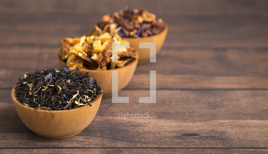 Loose Leaf Tea in a Wooden Bowl on a Wooden Table