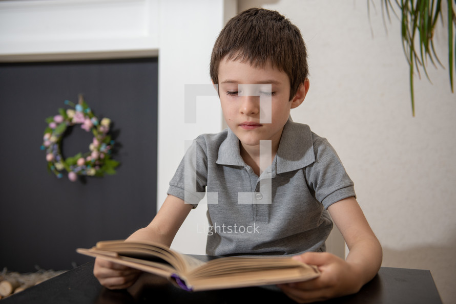 boy child reading a book 