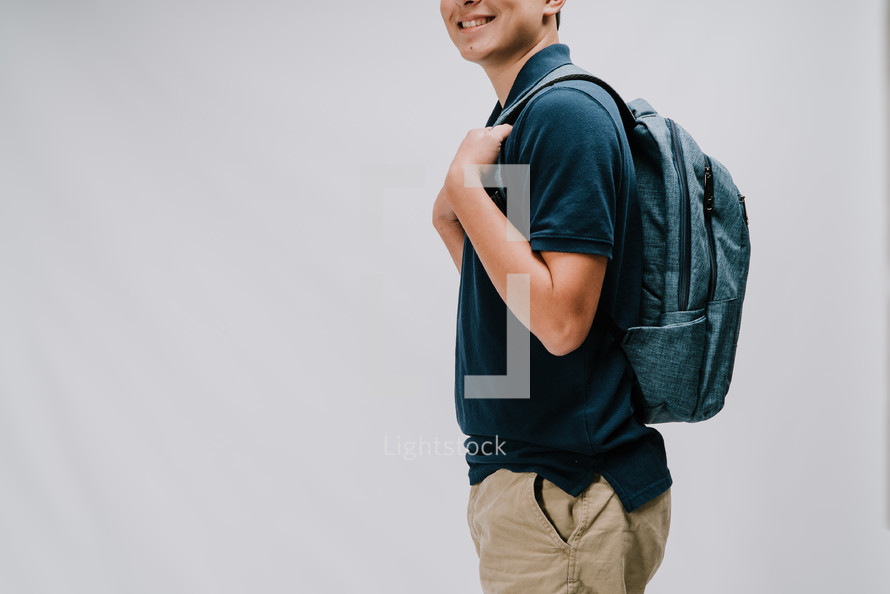 teen boy with a book bag 