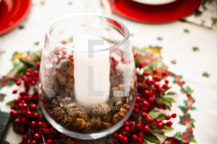 Candle holder with pine cones and berries at Christmas