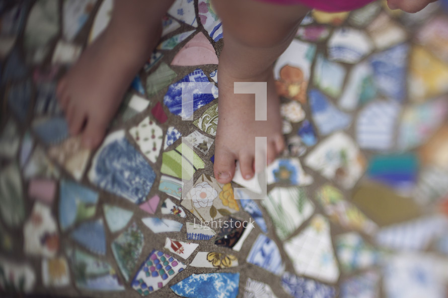 toddler feet on mosaic tiles 