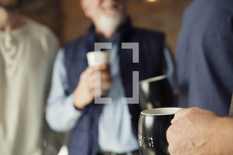 men's group with coffee mugs