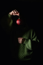 Hidden man's Hand Hangs An Ornament Christmas Ball